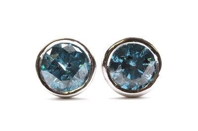 Lot 80 - A pair of white gold treated blue diamond stud earrings