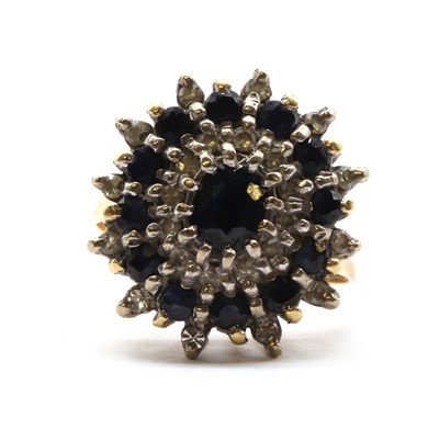 Lot 157 - A gold sapphire and diamond cluster ring