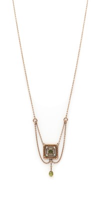 Lot 21 - An Edwardian gold peridot and split pearl pendant