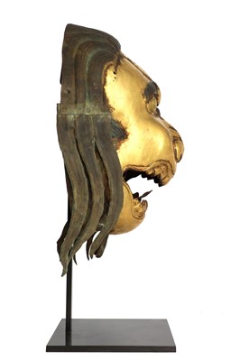 Lot 146 - A gilt-copper repoussé snow lion mask