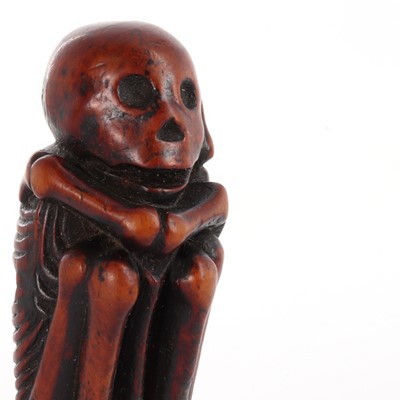Lot 118 - A Japanese carved boxwood netsuke depicting a skeleton