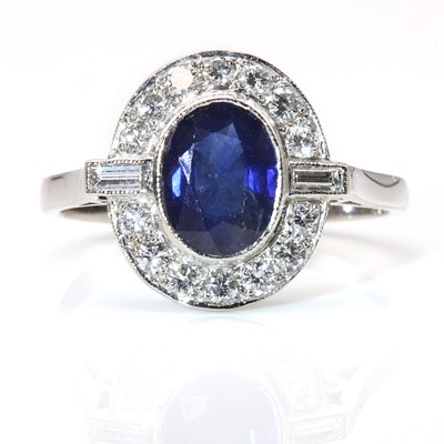 Lot 274 - A sapphire and diamond oval cluster ring