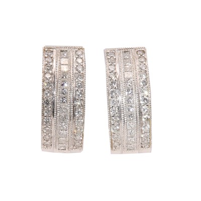 Lot 370 - A pair of Continental three row diamond set cuff style earrings