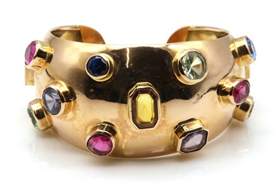 Lot 139 - A Continental synthetic sapphire and synthetic spinel set torque bangle, c.1950