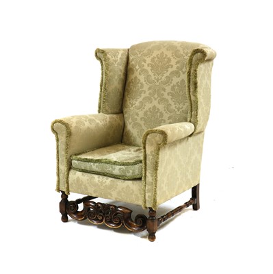 Lot 489 - A 17th-century style wingback armchair