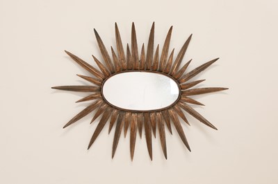 Lot 476 - A Hollywood Regency-style copper-coloured mirror