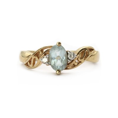 Lot 199 - A gold blue topaz and diamond three stone ring