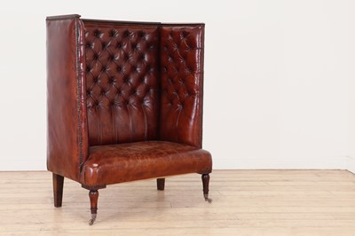 Lot 27 - A buttoned-leather high-back wing chair