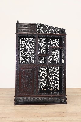 Lot 210 - A carved and pierced hardwood cabinet