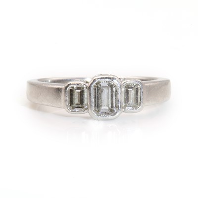 Lot 349 - A platinum three stone emerald cut diamond ring