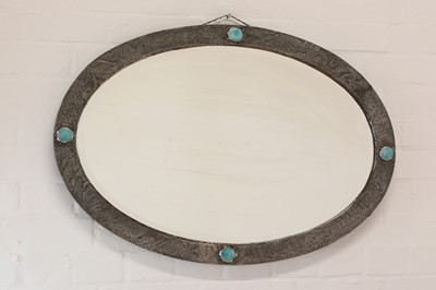 Lot 74 - An Arts and Crafts oval pewter mirror