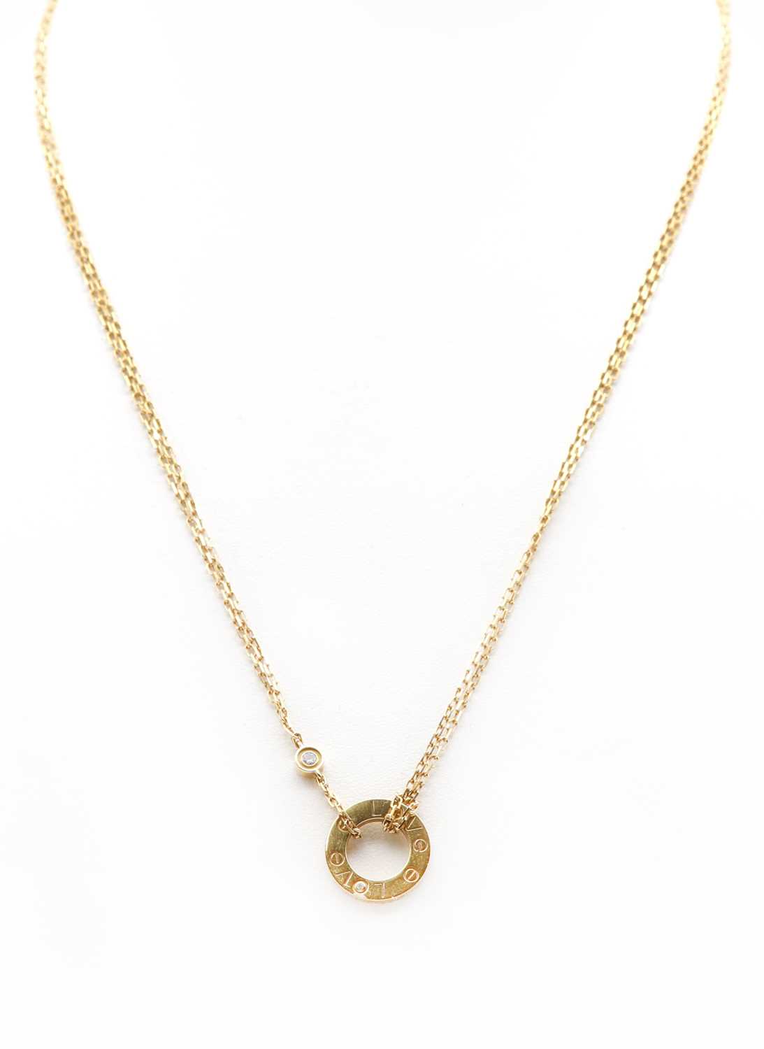 Lot 276 - An 18ct gold diamond set 'Love' necklace, by Cartier