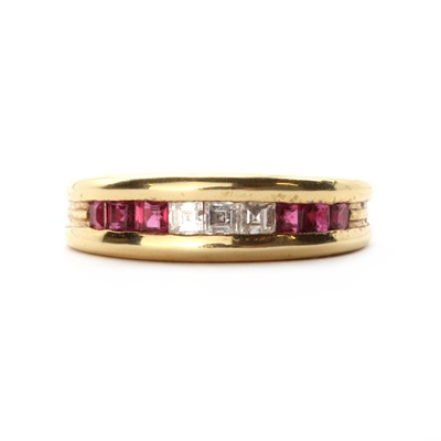 Lot 1189 - An 18ct gold diamond and ruby half eternity ring