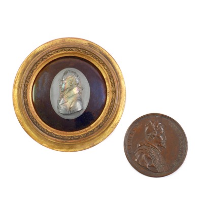 Lot 148 - An oval white metal, possibly silver, medallion