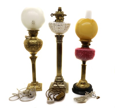 Lot 215 - A group of three Victorian brass table lamps