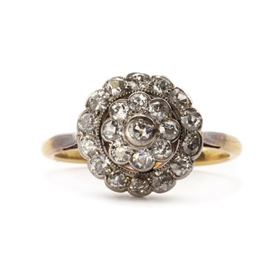 Lot 1012 - An early 20th century gold three row diamond cluster ring