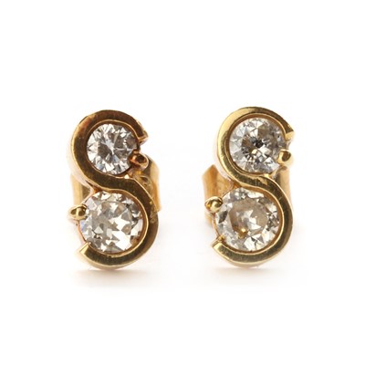 Lot 1125 - A pair of 18ct gold two stone diamond earrings