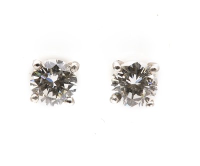 Lot 375 - A pair of 18ct white gold single stone diamond earrings