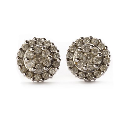 Lot 1175 - A pair of white gold diamond cluster earrings