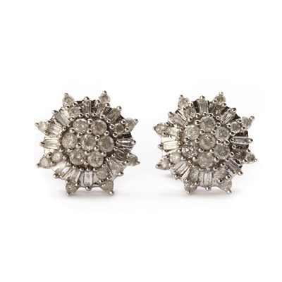 Lot 1173 - A pair of white gold diamond cluster earrings