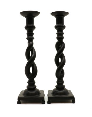 Lot 203 - A pair of patinated bronze pricket candlesticks