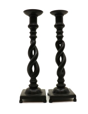 Lot 203 - A pair of patinated bronze pricket candlesticks