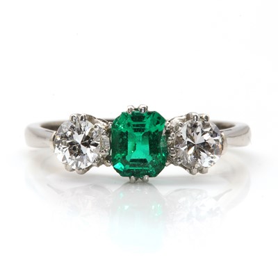 Lot 410 - A three stone emerald  and diamond ring