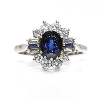 Lot 270 - A platinum sapphire and diamond oval cluster ring