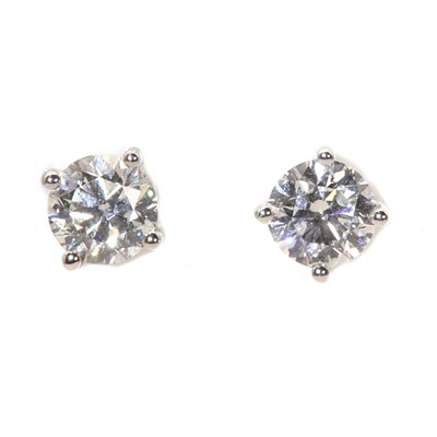 Lot 355 - A pair of 18ct white gold single stone diamond stud earrings