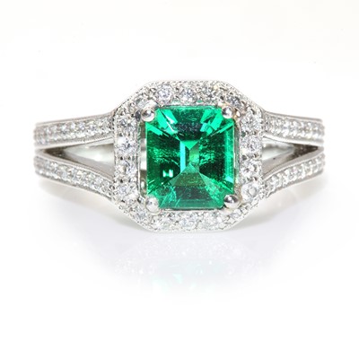 Lot 409 - A platinum Columbian emerald and diamond hexagonal cluster ring