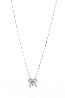 Lot 1170 - An 18ct white gold diamond set bow pendant