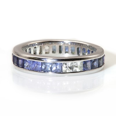 Lot 285 - An ombré sapphire set full eternity ring