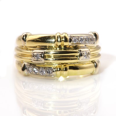 Lot 214 - A Continental two colour gold diamond set band ring