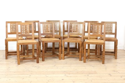 Lot 102 - A set of ten Robert 'Mouseman' Thompson oak dining chairs