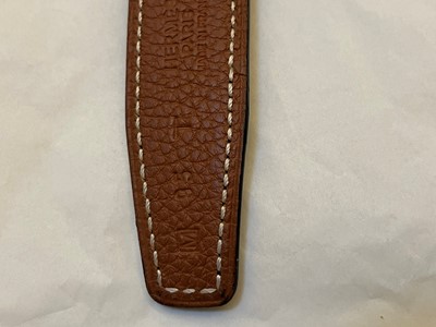 Lot 1497 - An Hermès black/ tan reversible belt