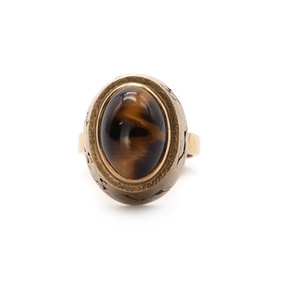 Lot 1083 - A South African gold single stone tiger’s eye ring