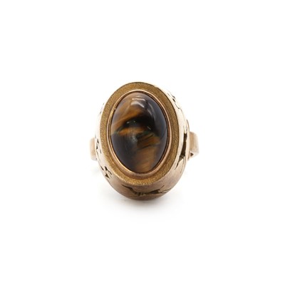 Lot 1085 - A South African gold single stone tiger’s eye ring