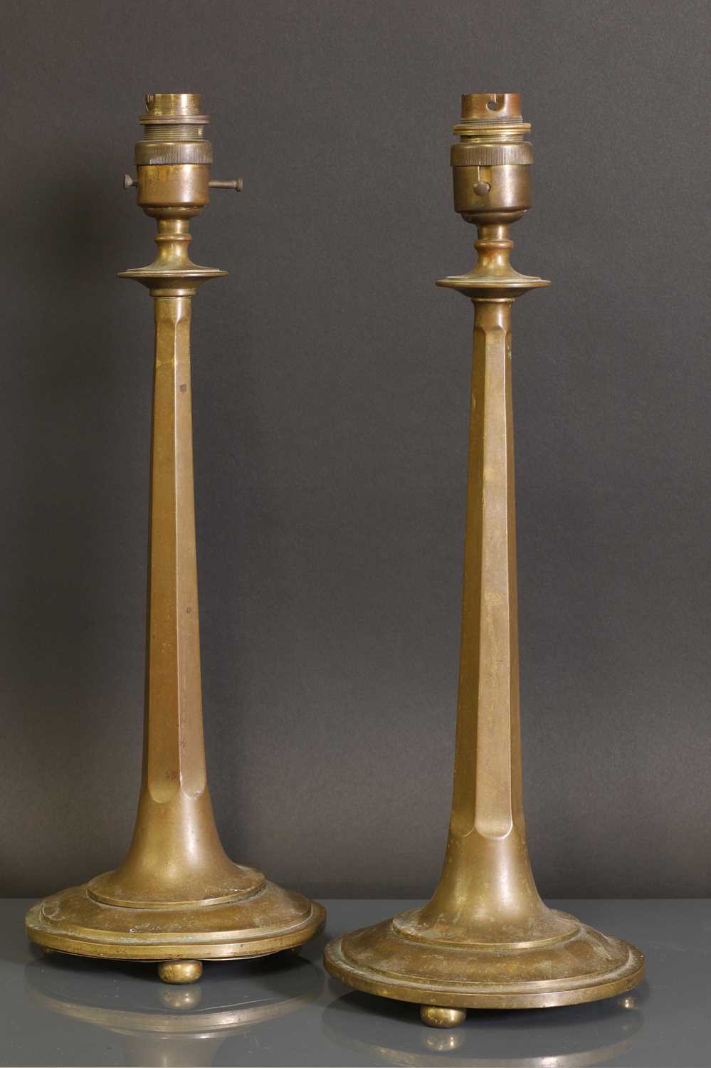 Lot 45 - A pair of Arts and Crafts bronze candlesticks