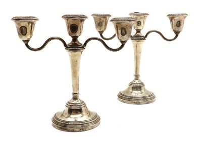 Lot 14 - A pair of silver three branch candlesticks