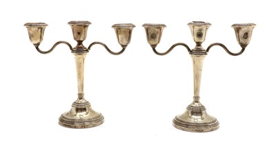 Lot 14 - A pair of silver three branch candlesticks