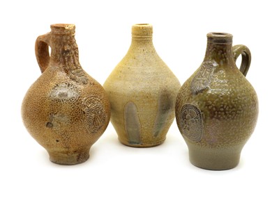 Lot 136 - Three stoneware bellarmine jugs
