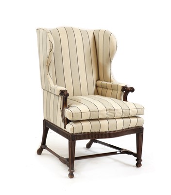 Lot 555 - A mahogany wingback chair