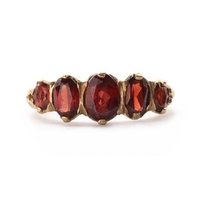 Lot 1194 - A 9ct gold five stone garnet ring