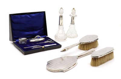 Lot 124 - A silver three piece dressing table set
