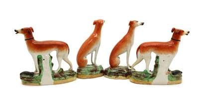 Lot 113 - A group of four Staffordshire pottery greyhounds