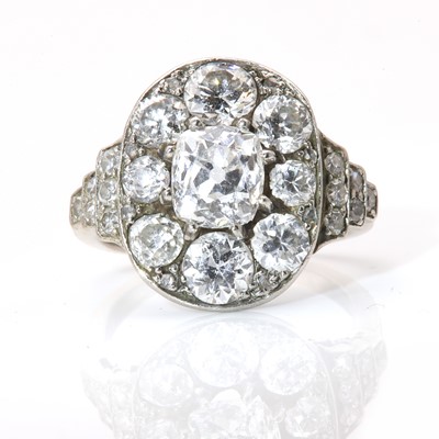 Lot 48 - A diamond set oval cluster ring, c.1940