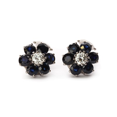 Lot 117 - A pair of white gold diamond and sapphire cluster clip earrings