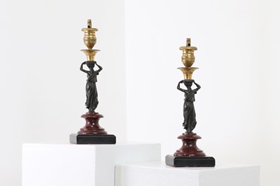 Lot 161 - A pair of bronze and ormolu candlesticks