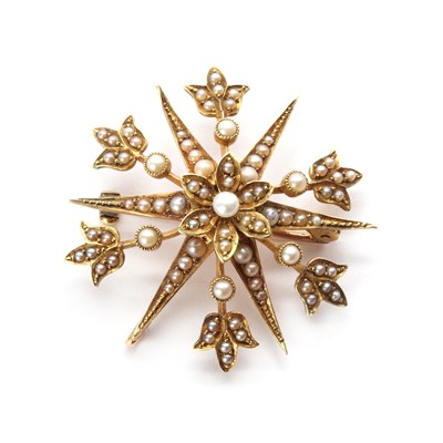 Lot 1030 - An Edwardian gold split pearl star brooch/pendant