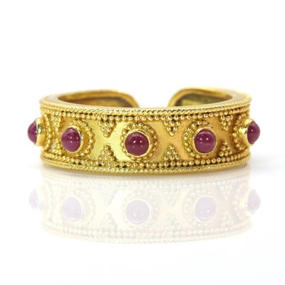 Lot 312 - A gold and ruby Etruscan style torque ring, by Ilias Lalaounis